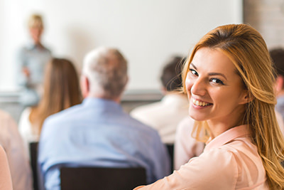 Smiling woman looking over shoulder during class
